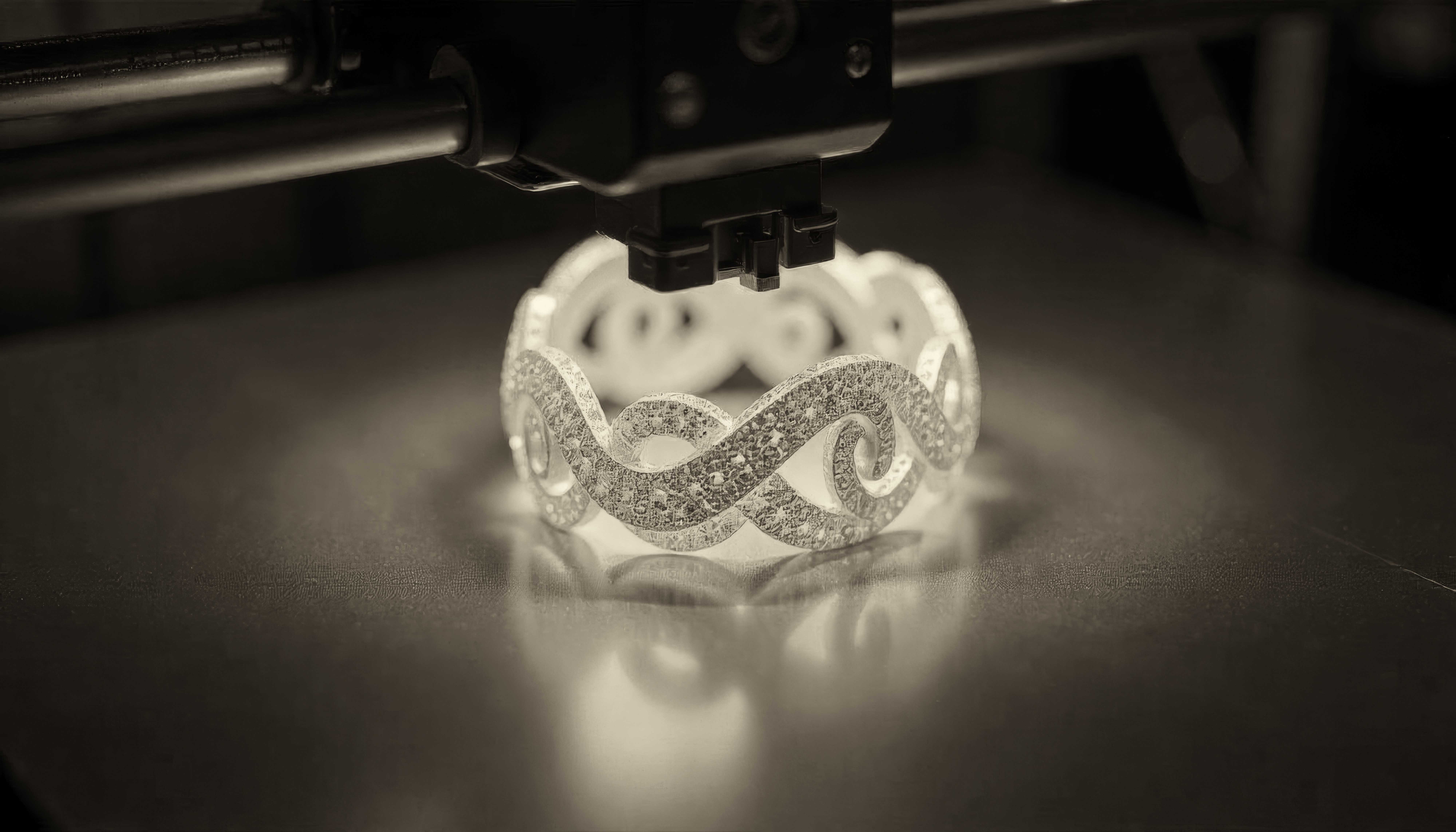 3D printer creating an intricate infinity-pattern diamond ring, showcasing advanced jewelry manufacturing technology in dramatic lighting